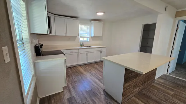 a kitchen with a sink dishwasher a refrigerator and wooden cabinets