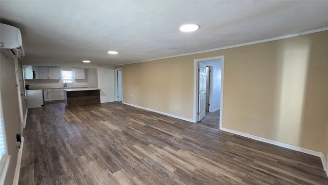 a view of a kitchen with a dishwasher and wooden floor