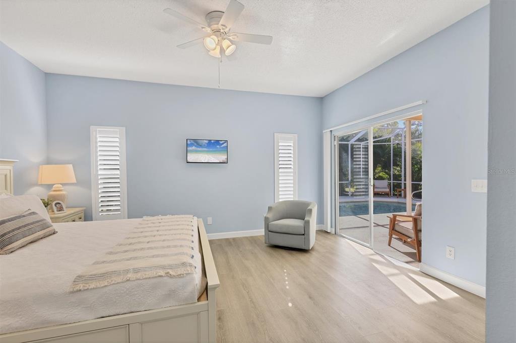 5956 Rachele Drive Sarasota, FL 34243 - Photo 15 of 37 a bedroom with a large bed and a chair
