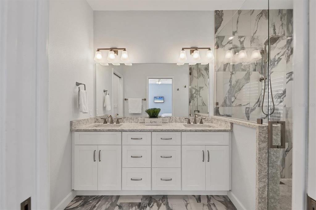 5956 Rachele Drive Sarasota, FL 34243 - Photo 17 of 37 a bathroom with a granite countertop sink and a mirror