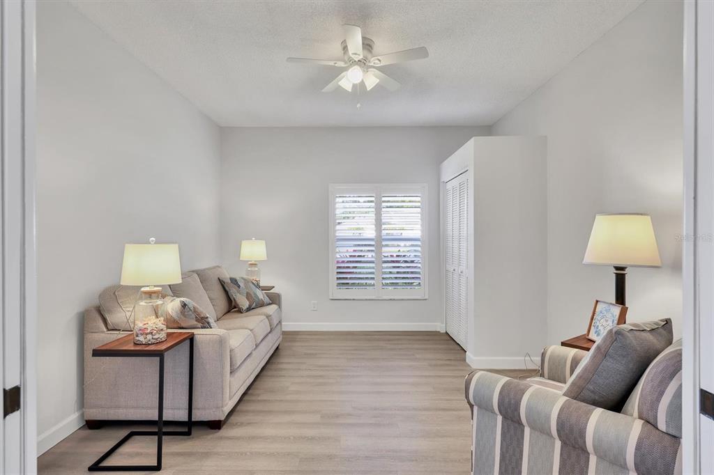 5956 Rachele Drive Sarasota, FL 34243 - Photo 22 of 37 a living room with furniture and a lamp