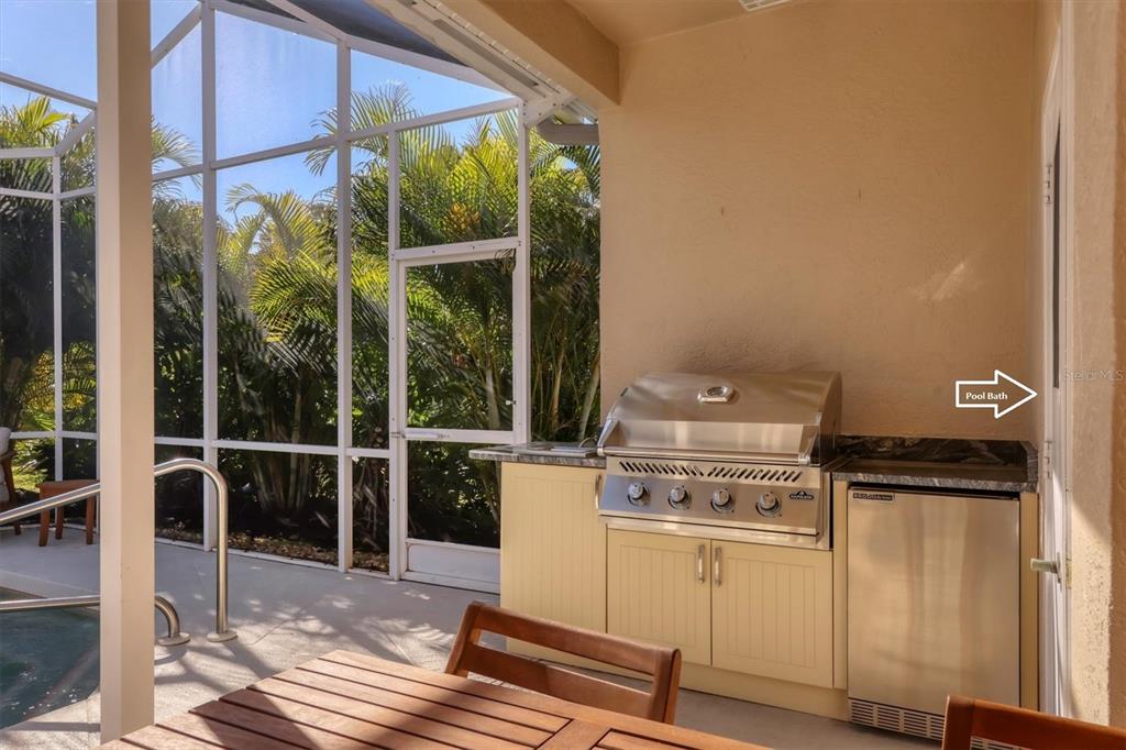 5956 Rachele Drive Sarasota, FL 34243 - Photo 26 of 37 a open kitchen with white cabinets and white appliances