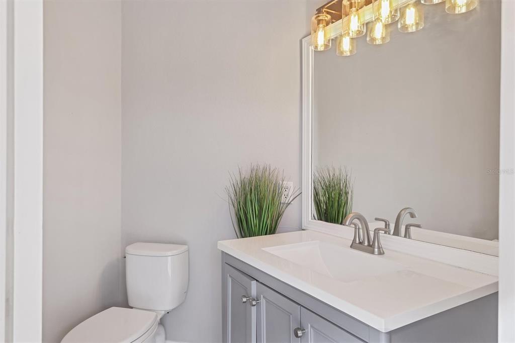 5956 Rachele Drive Sarasota, FL 34243 - Photo 27 of 37 a bathroom with a sink vanity mirror and toilet