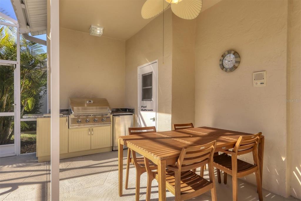 5956 Rachele Drive Sarasota, FL 34243 - Photo 28 of 37 a kitchen with a table and a refrigerator