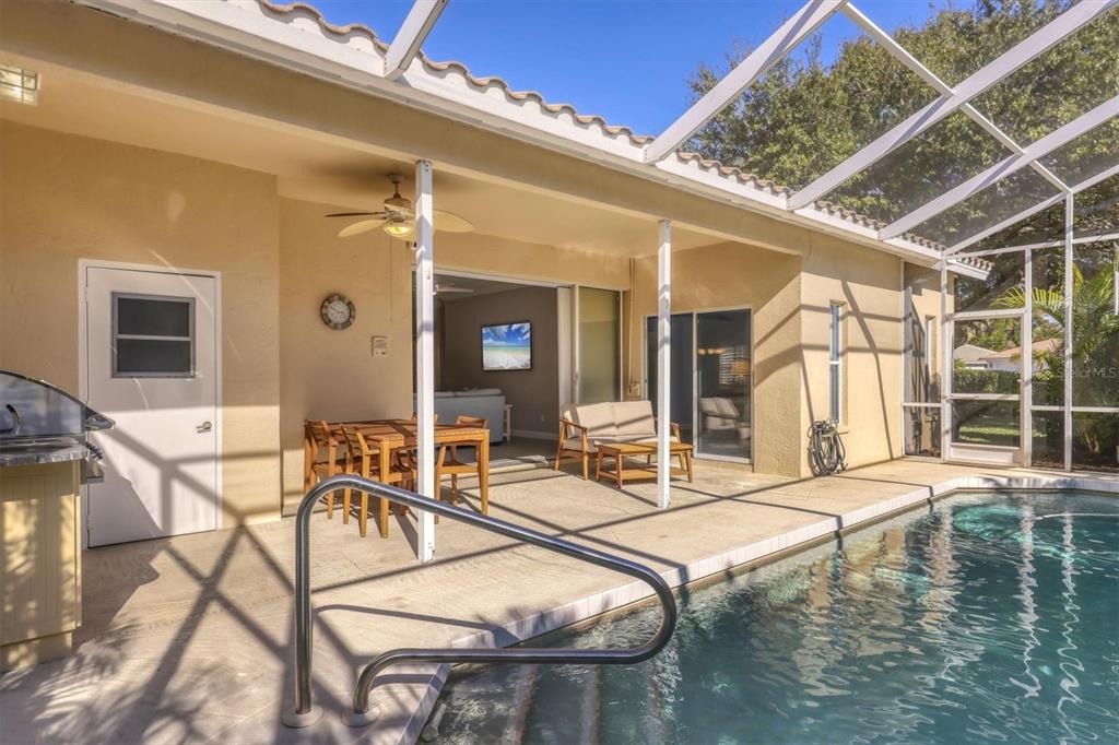 5956 Rachele Drive Sarasota, FL 34243 - Photo 30 of 37 a swimming pool with outdoor seating and windows