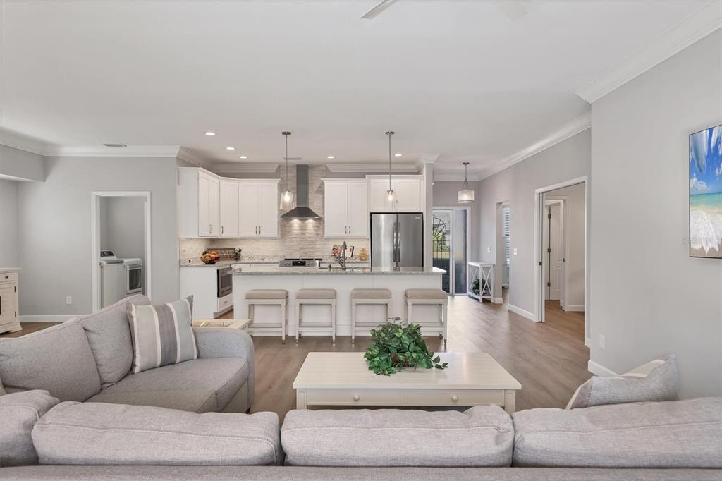 5956 Rachele Drive Sarasota, FL 34243 - Photo 6 of 37 a living room with stainless steel appliances kitchen island granite countertop furniture and a view of kitchen