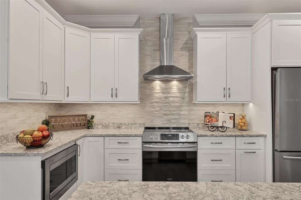 5956 Rachele Drive Sarasota, FL 34243 - Photo 10 of 37 a kitchen with cabinets stainless steel appliances and sink