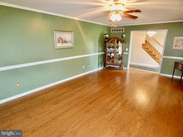 a kitchen with stainless steel appliances granite countertop a sink dishwasher stove and cabinets with wooden floor