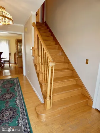 a view of a room with wooden floor and furniture