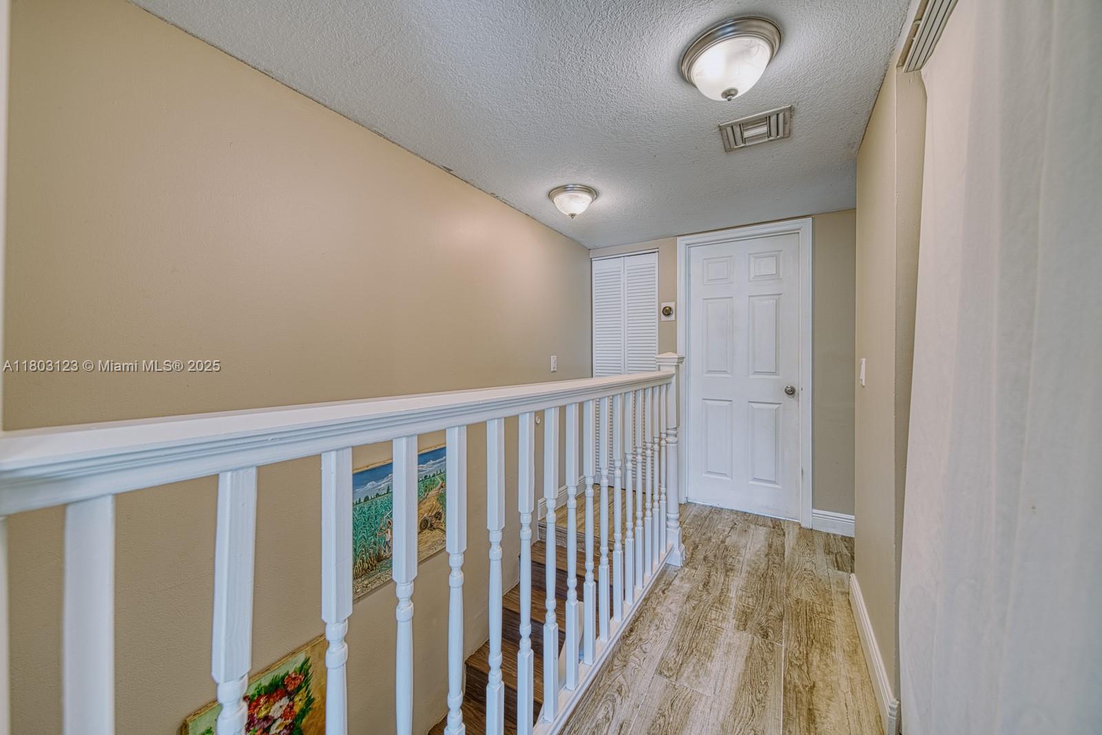 Glenvar Heights Miami, FL 33155 - Photo 13 of 30 a view of a hallway with wooden floor