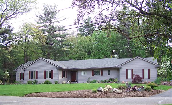 a front view of a house with a garden
