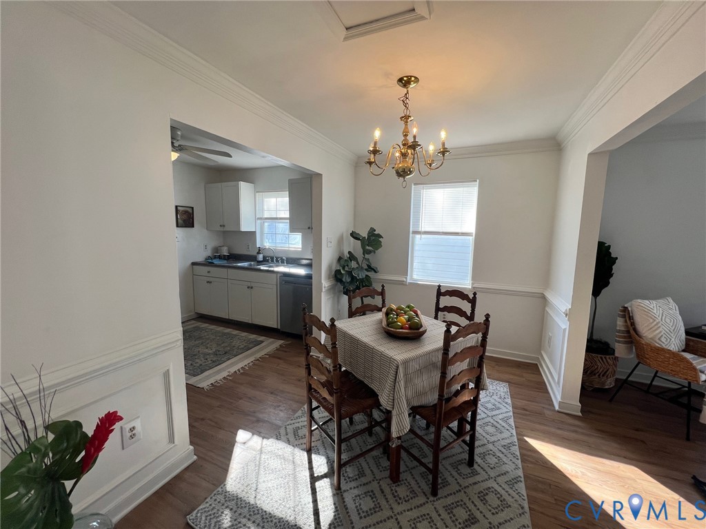 2604 Perry Street Richmond, VA 23225 - Photo 11 of 30 a view of a dining room with furniture and a chandelier