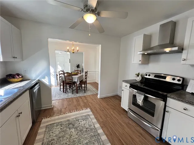 a kitchen with stainless steel appliances granite countertop a stove and cabinets