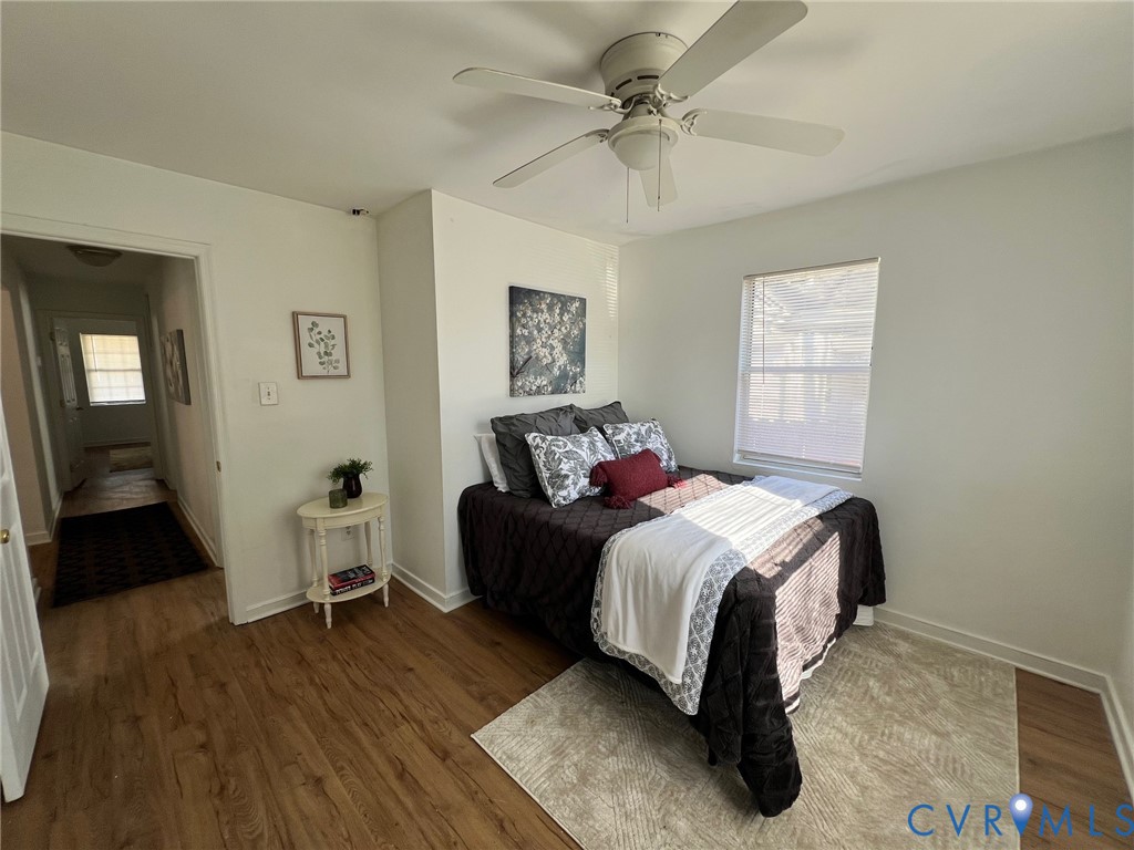 2604 Perry Street Richmond, VA 23225 - Photo 19 of 30 a bedroom with a bed and wooden floor