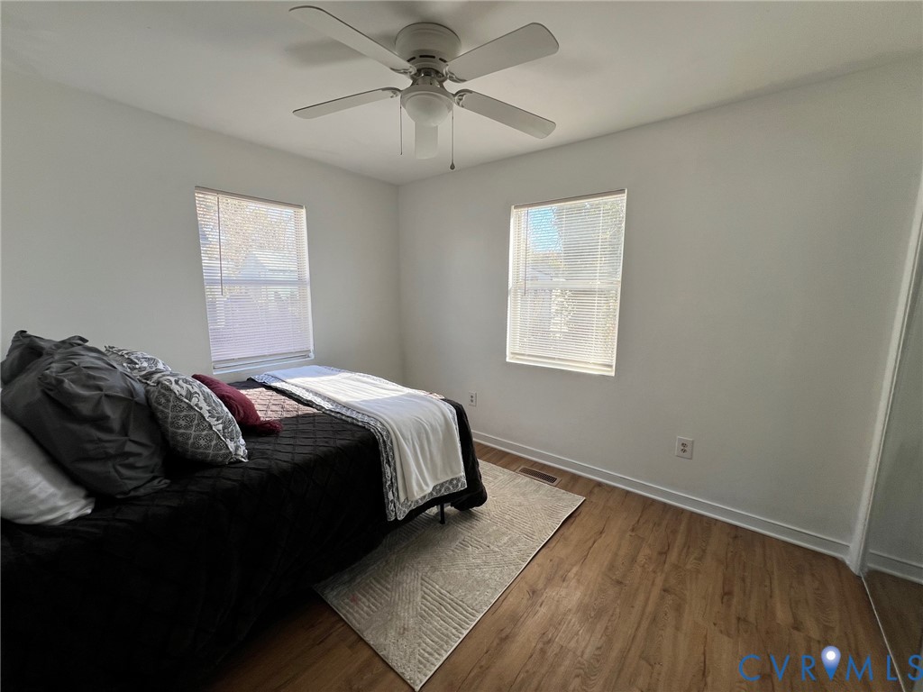 2604 Perry Street Richmond, VA 23225 - Photo 20 of 30 a bedroom with a bed and wooden floor