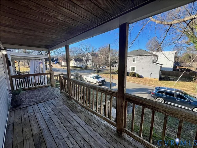 a view of a balcony with wooden floor