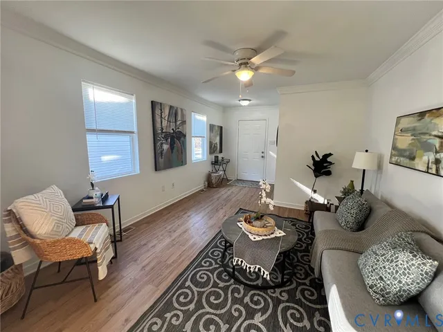 a living room with furniture and wooden floor