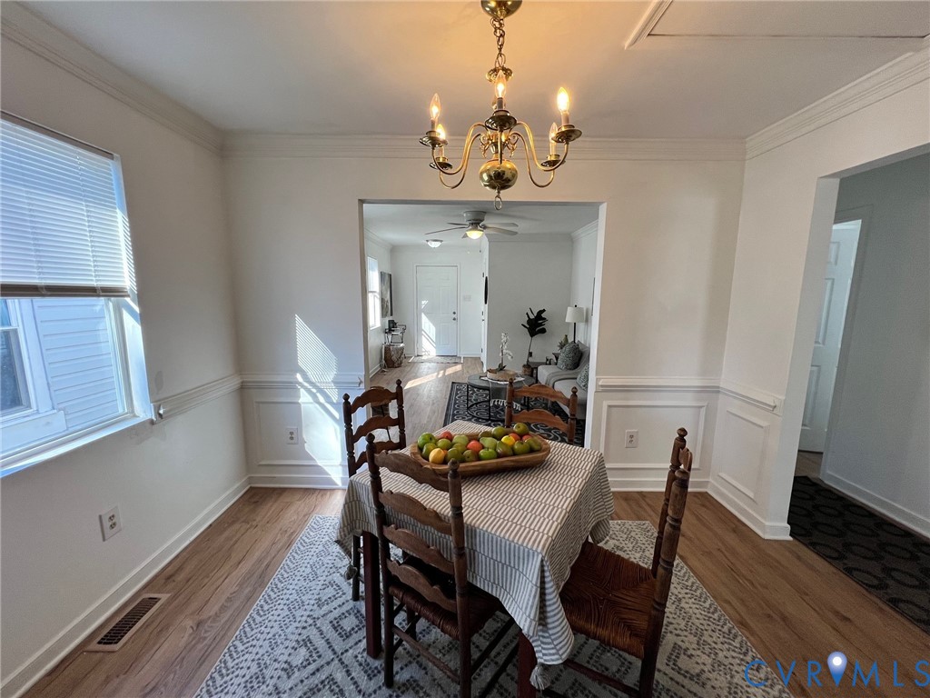 2604 Perry Street Richmond, VA 23225 - Photo 8 of 30 a view of a dining room with furniture a chandelier and wooden floor