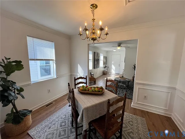 a view of a dining room with furniture and a chandelier