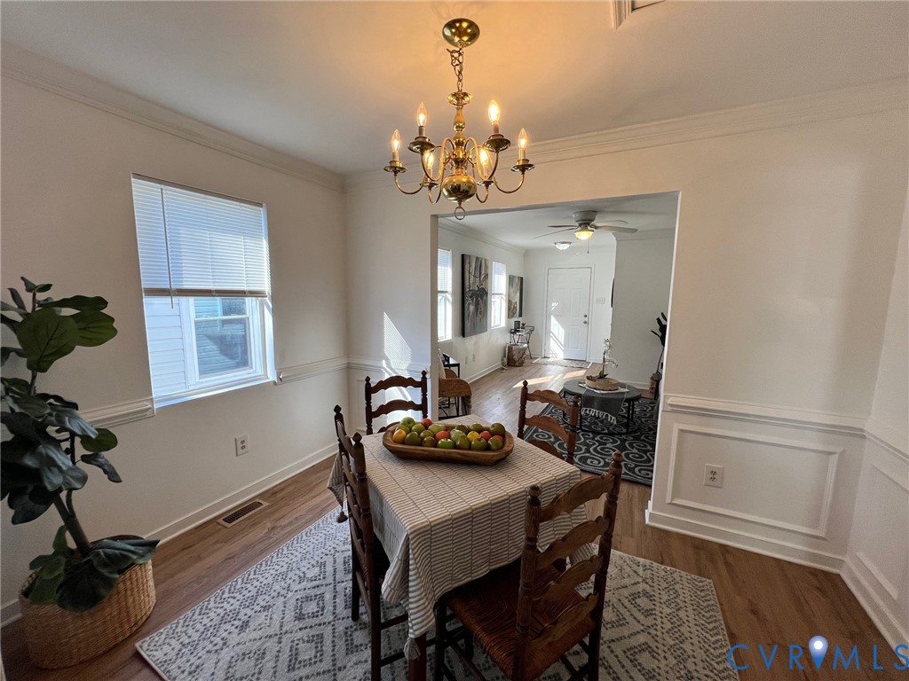 2604 Perry Street Richmond, VA 23225 - Photo 9 of 30 a view of a dining room with furniture and a chandelier