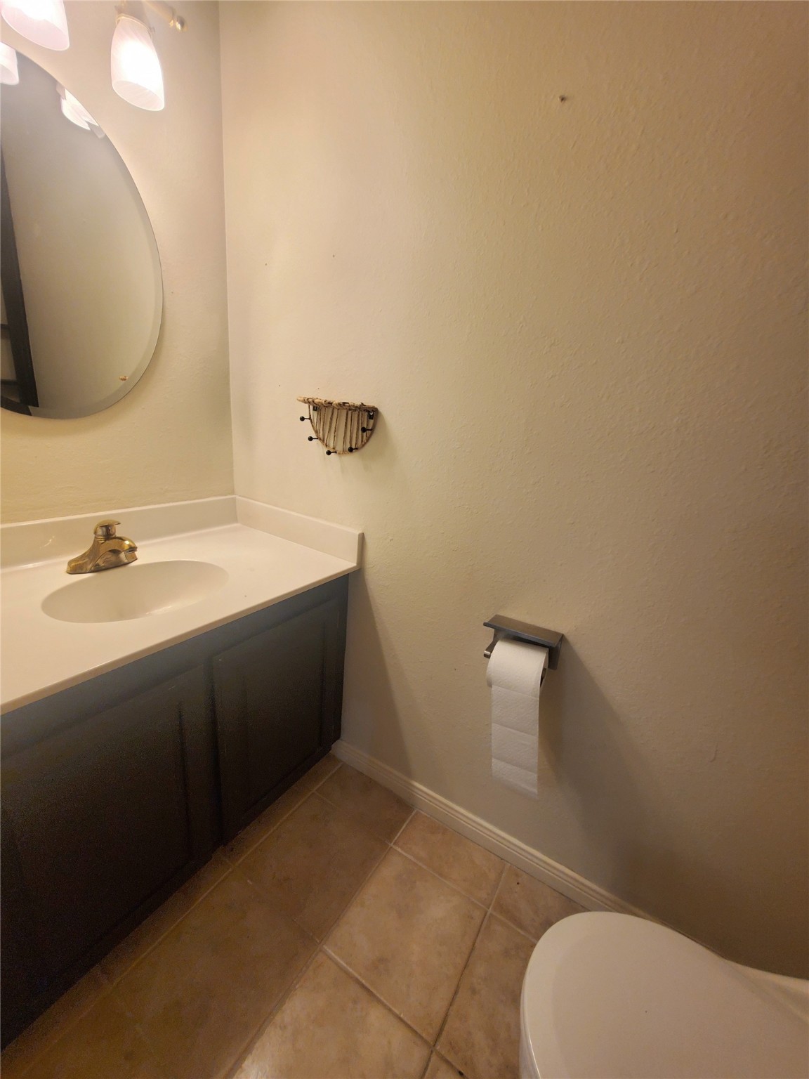 2030 Plantation Drive, Unit B2 Conroe, TX 77301 - Photo 11 of 20 a bathroom with a sink a toilet and mirror