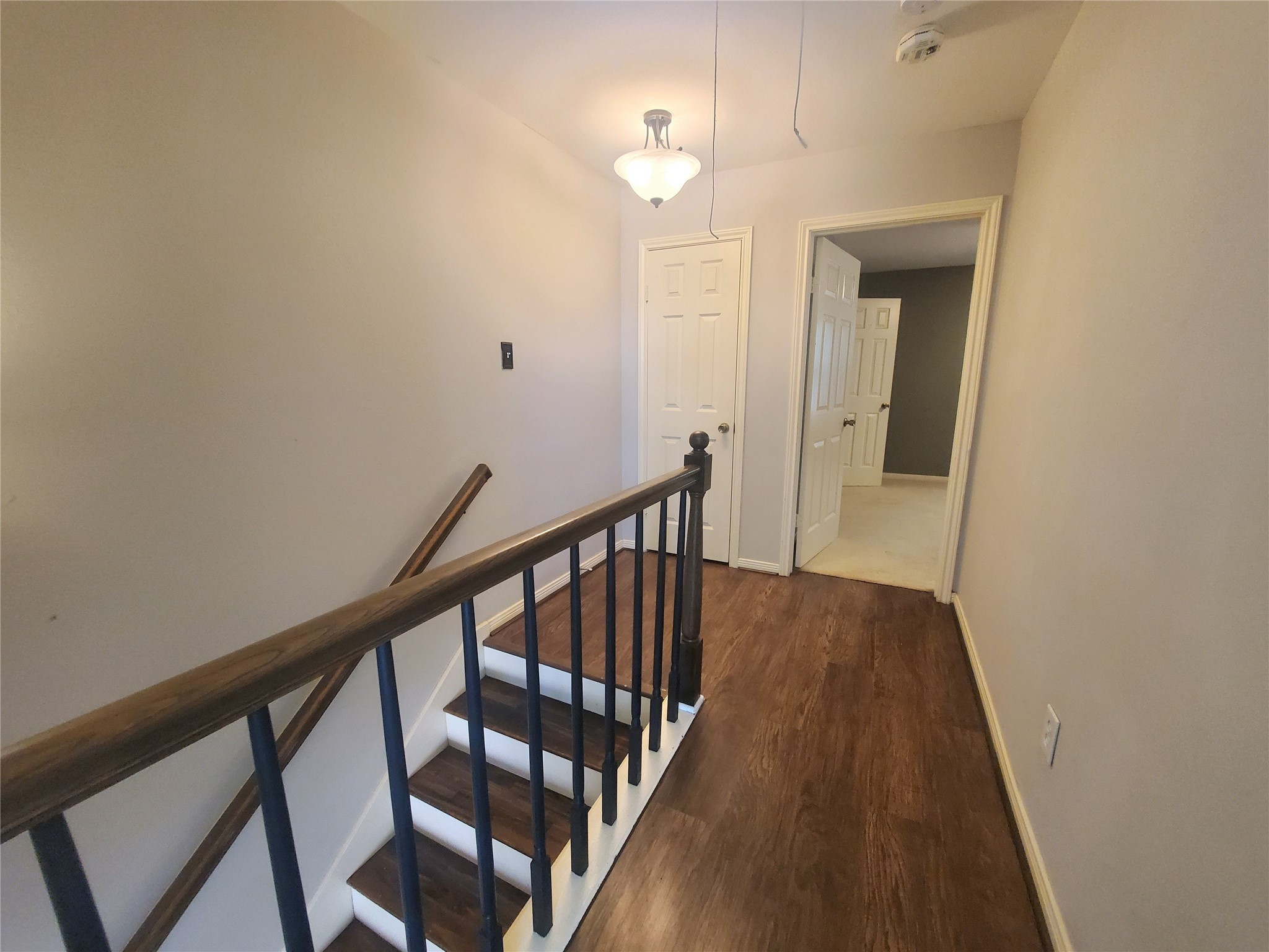 2030 Plantation Drive, Unit B2 Conroe, TX 77301 - Photo 13 of 20 a view of a hallway with wooden floor and staircase
