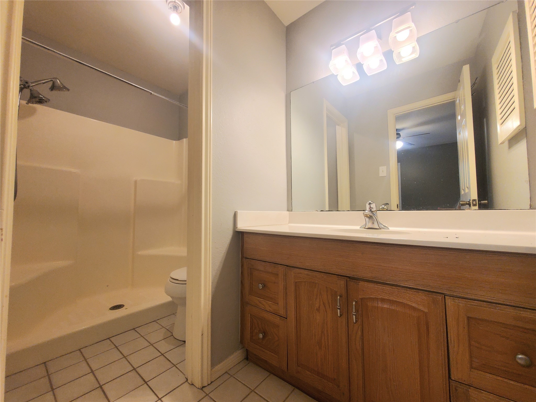 2030 Plantation Drive, Unit B2 Conroe, TX 77301 - Photo 15 of 20 a bathroom with a double vanity sink mirror and shower