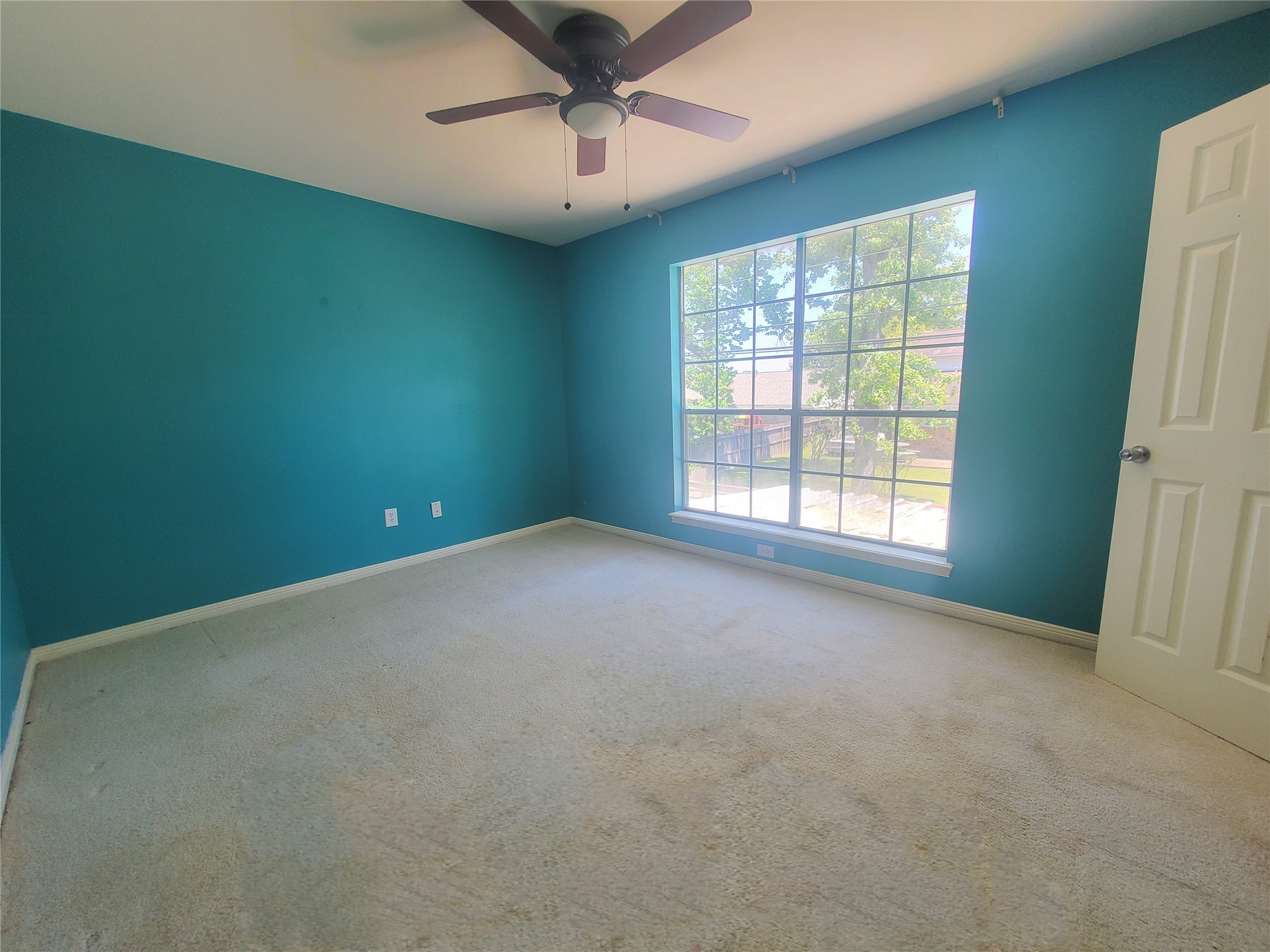 2030 Plantation Drive, Unit B2 Conroe, TX 77301 - Photo 17 of 20 an empty room with windows and fan