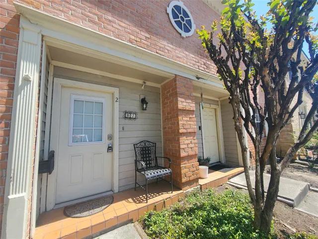a kitchen with a sink a refrigerator a counter top space and cabinets