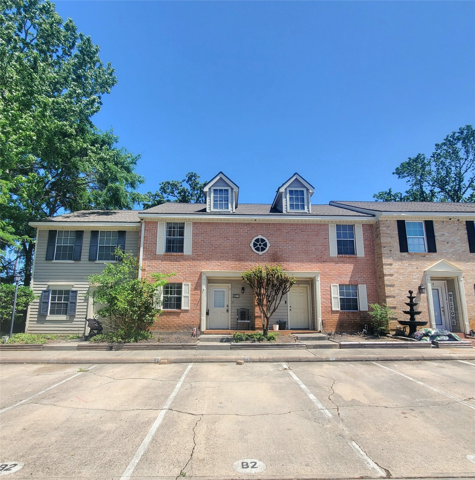 2030 Plantation Drive, Unit B2 Conroe, TX 77301 - Photo 3 of 20 front view of a house with a yard