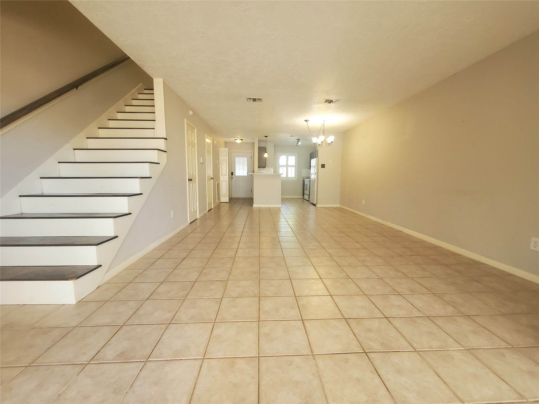 2030 Plantation Drive, Unit B2 Conroe, TX 77301 - Photo 9 of 20 a view of an empty room and stairs