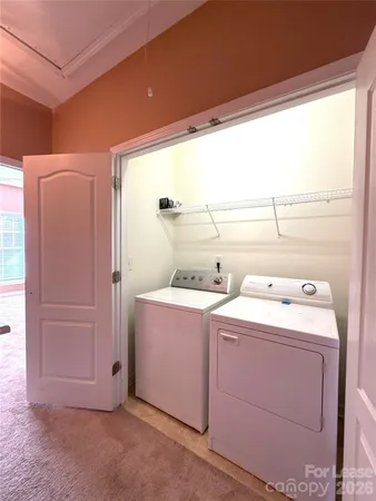 a view of storage and utility room with washer and dryer