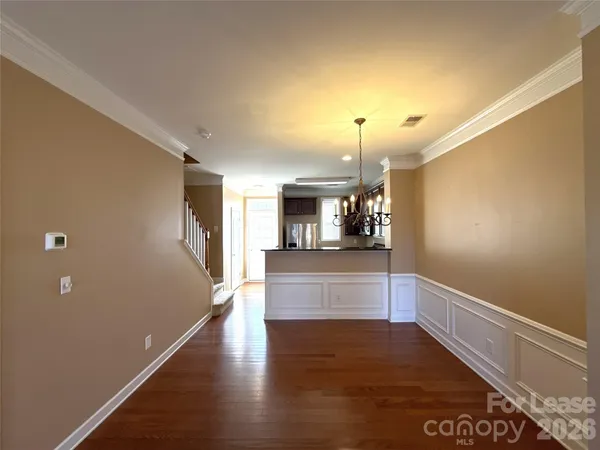 a view of kitchen and hall with wooden floor