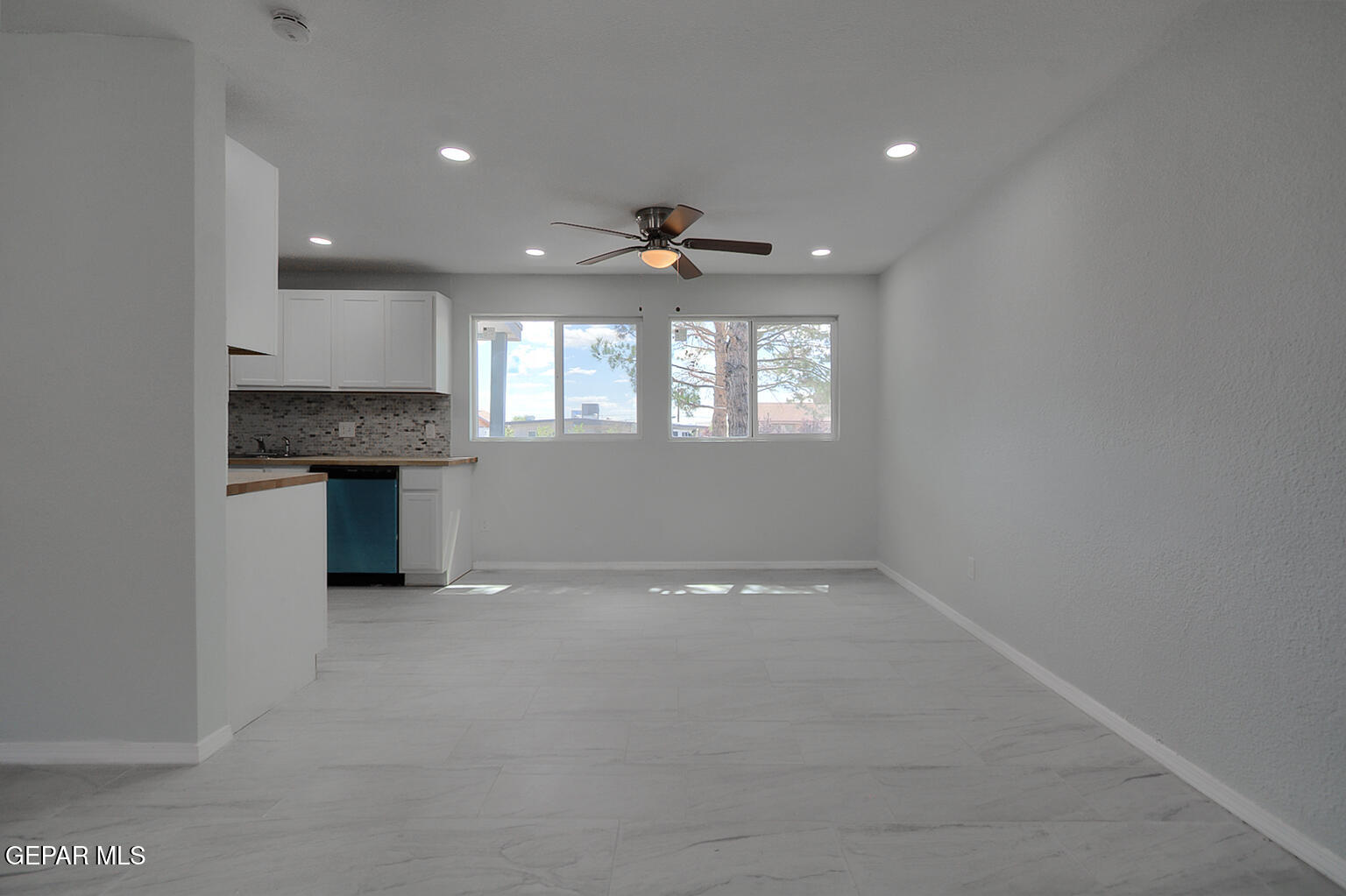 6247 Arapaho Road El Paso, TX 79905 - Photo 15 of 43 an empty room with windows and ceiling fan