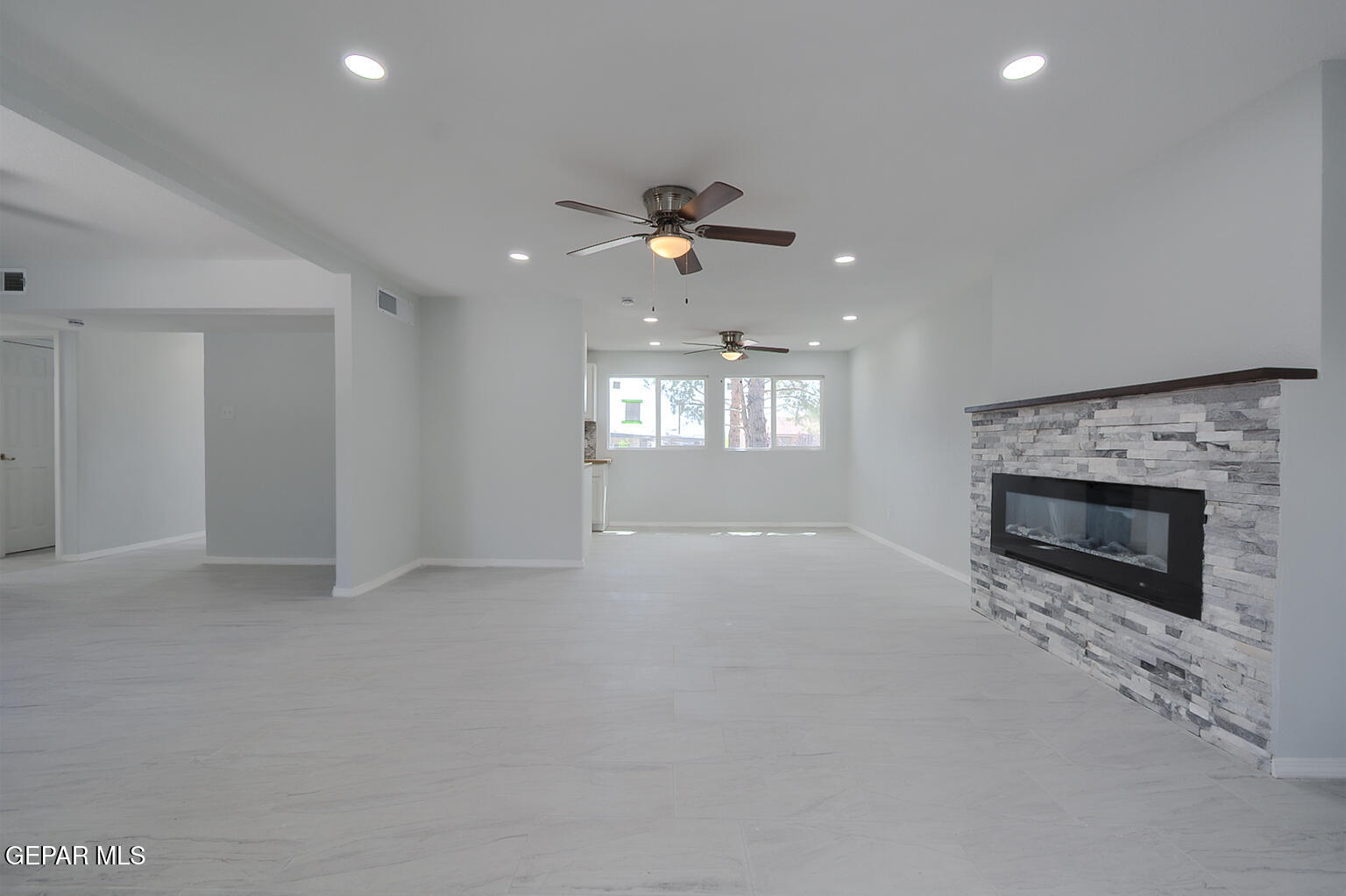 6247 Arapaho Road El Paso, TX 79905 - Photo 42 of 43 an empty room with windows and fireplace