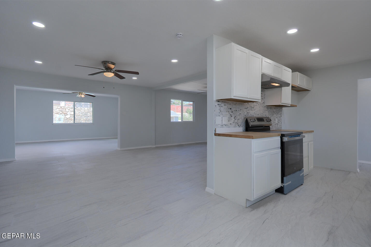 6247 Arapaho Road El Paso, TX 79905 - Photo 43 of 43 a kitchen with stainless steel appliances granite countertop a stove a sink and a refrigerator