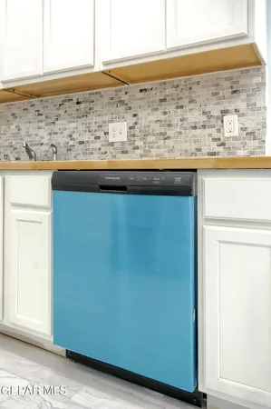 a kitchen that has a sink and a stove in it