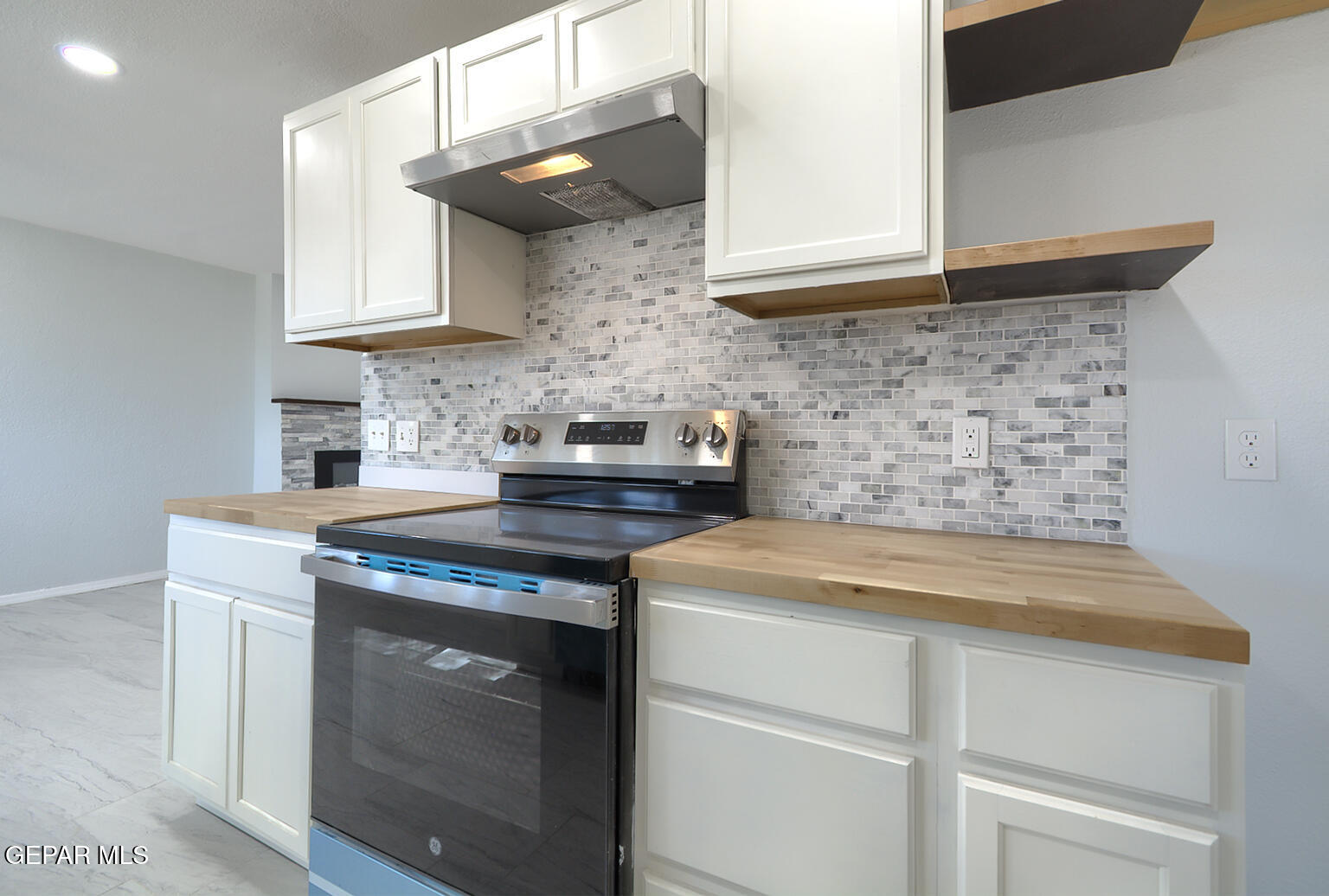6247 Arapaho Road El Paso, TX 79905 - Photo 24 of 43 a kitchen with stainless steel appliances granite countertop a sink stove and cabinets