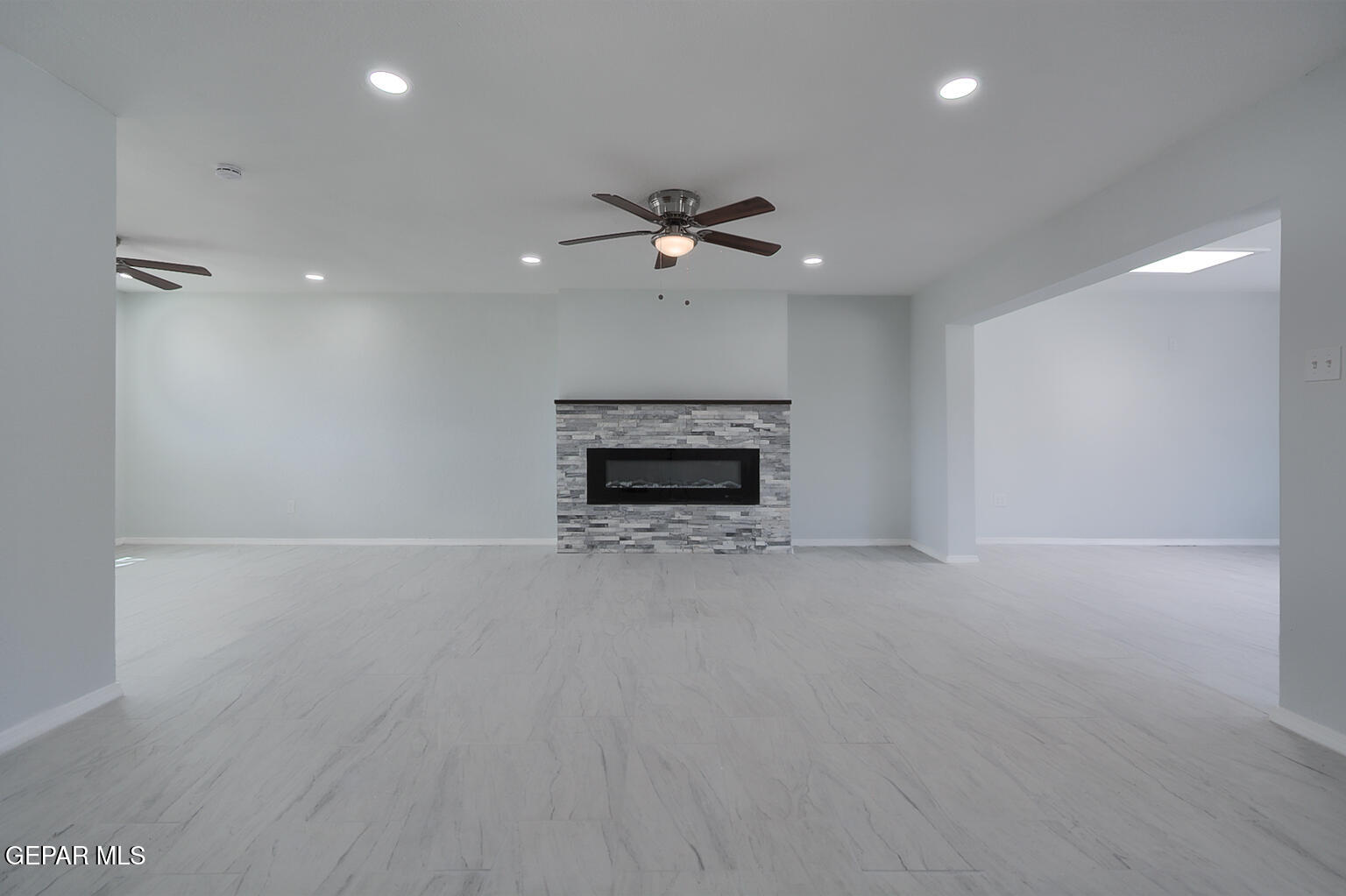 6247 Arapaho Road El Paso, TX 79905 - Photo 27 of 43 an empty room with fireplace and fan