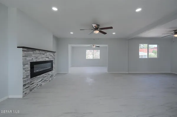 a view closed kitchen island a sink a counter space and a stove top oven