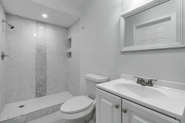 an empty room with fireplace and fan