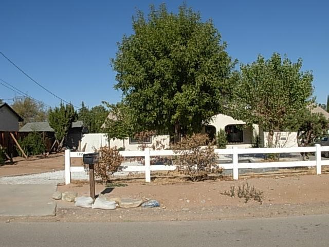 14559 Ranchero Road Hesperia, CA 92345 - Photo 1 of 1 a white house with a outdoor space and sitting space