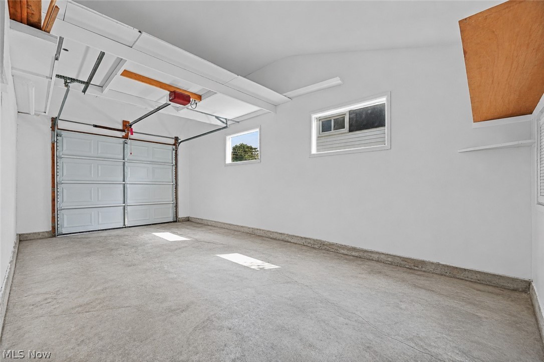 150 Graham Road Cuyahoga Falls, OH 44223 - Photo 26 of 38 Single-car garage with a paneled overhead door, concrete flooring, and multiple windows providing natural light