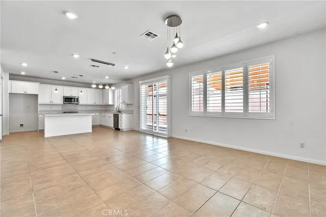 a large kitchen with stainless steel appliances granite countertop a large stove top oven and cabinets