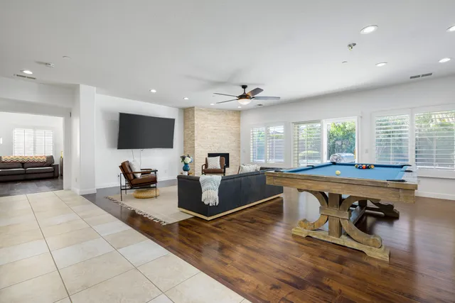 a living room with furniture a flat screen tv and a large window