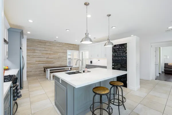a kitchen with a counter space a sink appliances and cabinets