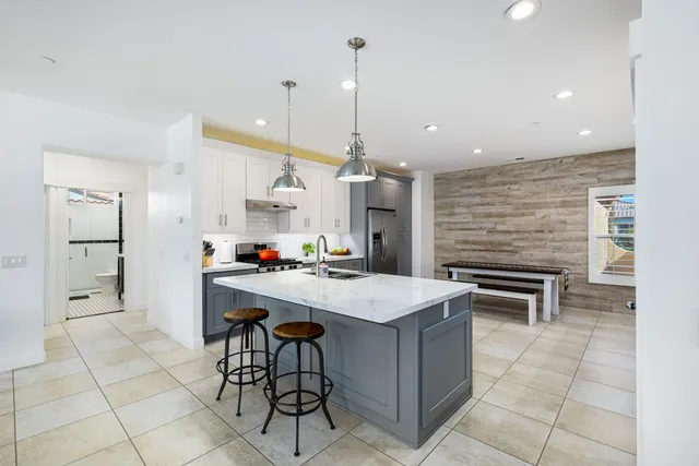 a kitchen with a sink a counter space and appliances