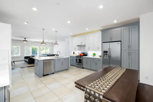 a large kitchen with a large counter top appliances and cabinets
