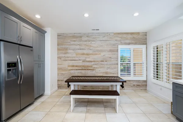 a view of kitchen with windows and refrigerator