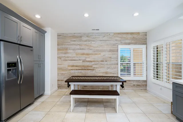 a view of kitchen with windows and refrigerator